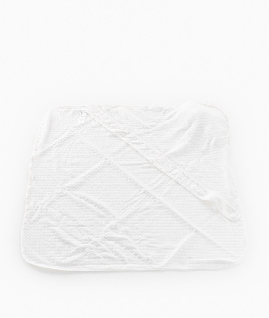 Back view of unfolded white diamond quilted cotton swaddle with velcro strip