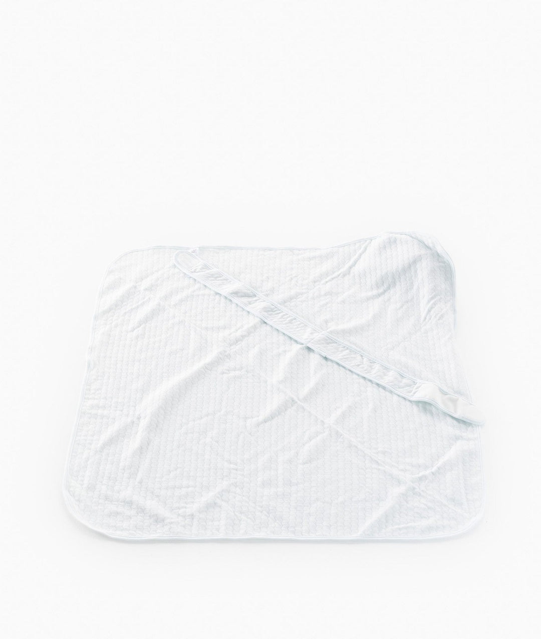 Back view of light blue cotton swaddle showing diamond quilting texture and adjustable fastening strap