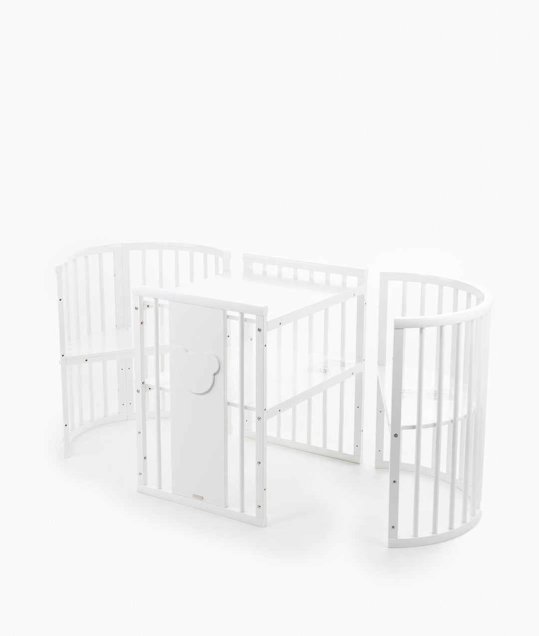 White baby cot with teddy bear design styled in a neutral nursery room