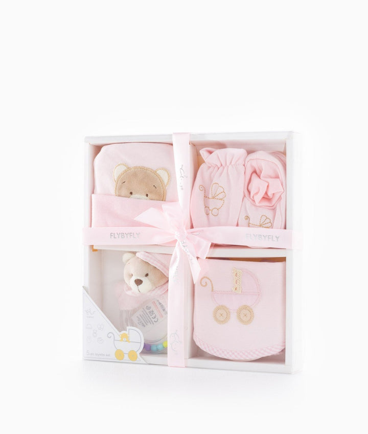 Pink ribbon tied gift box revealing baby essentials set