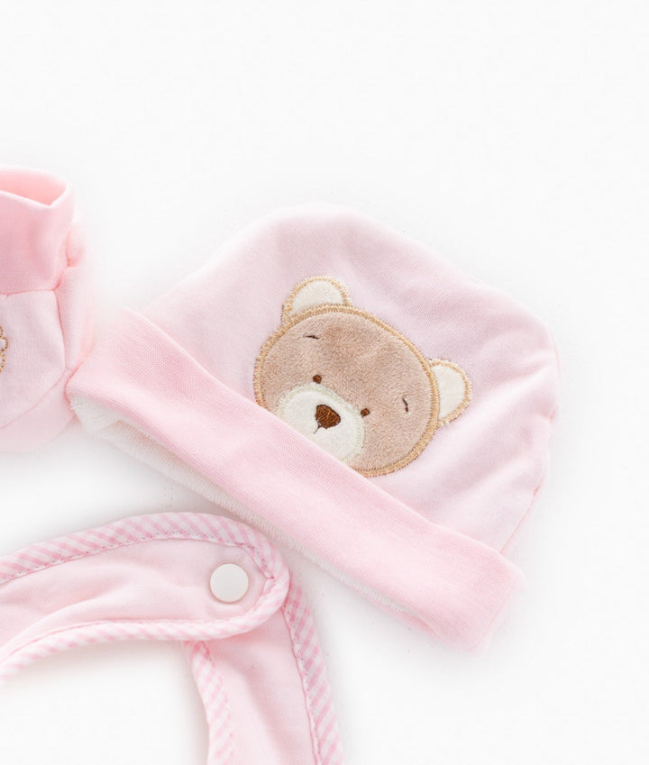 Pink baby hat with teddy bear patch and snap-button bib