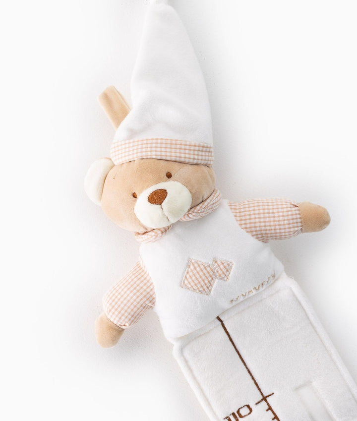 Beige teddy bear head on white baby growth chart featuring tall pointed hat with peach gingham trim