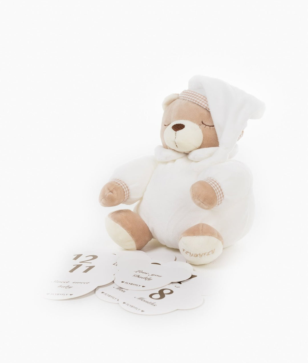 Beige teddy bear behind fan of white milestone cards showing first year numbers