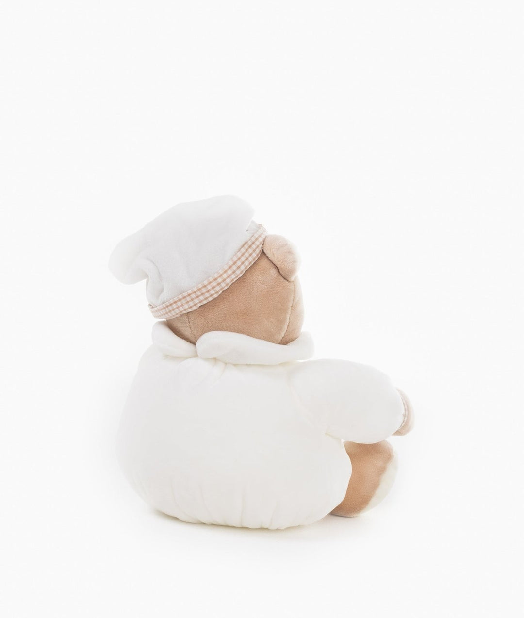 Back view of beige plush teddy bear in white hooded onesie with tan gingham trim