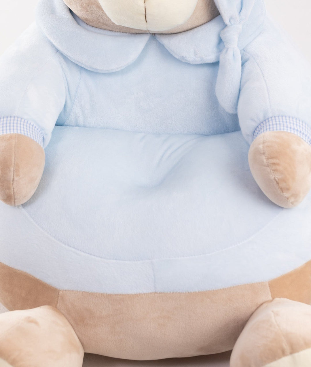Close-up of soft velvety blue seat texture and gingham trim on nursery armchair