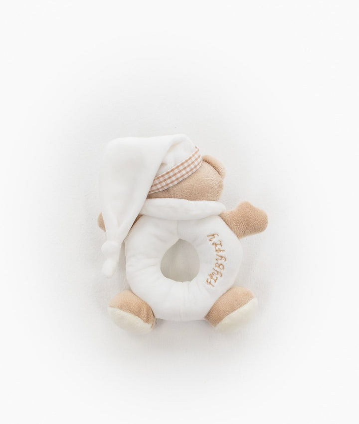 Close up of beige bear rattle with white nightcap and gold text ring