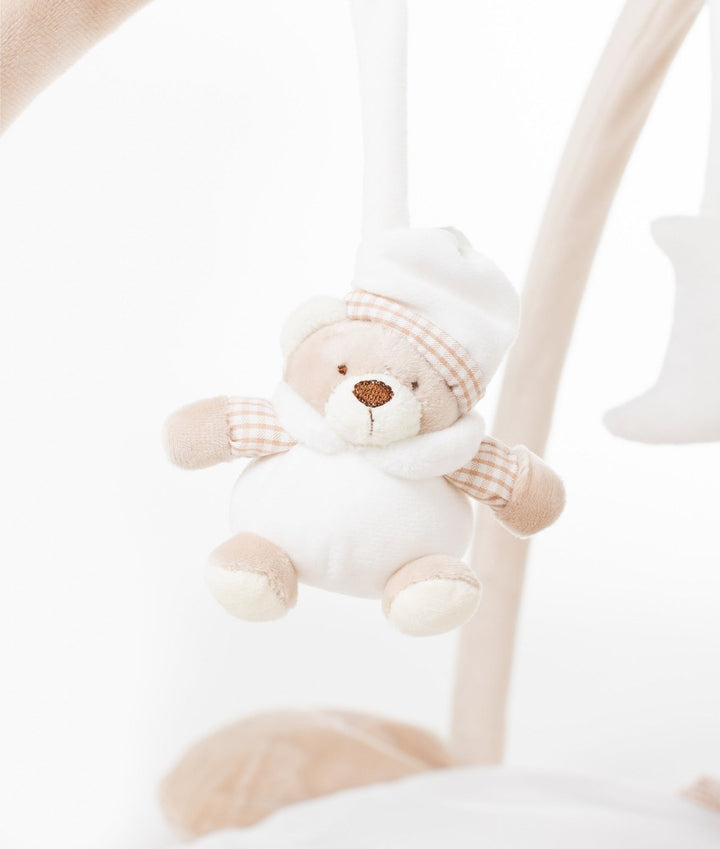 Close-up of hanging bear sensory toy with white nightcap and pink gingham accents