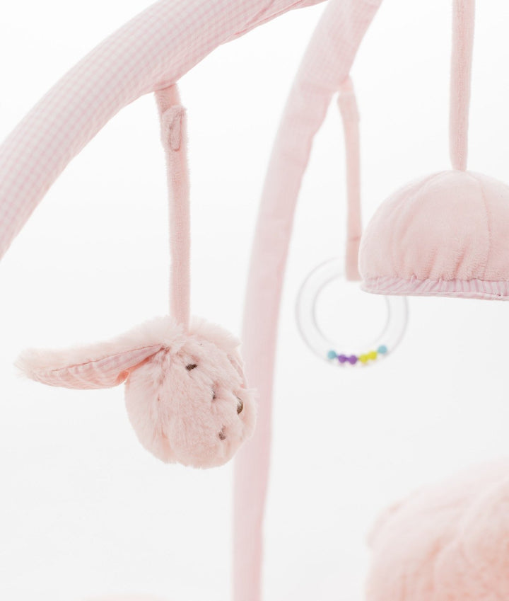 Pink gingham toy bar with hanging fluffy bunny, teether ring, and dome rattle sensory toys