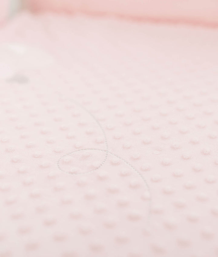 Macro texture of soft pink bubble dot fabric with raised dimpled pattern