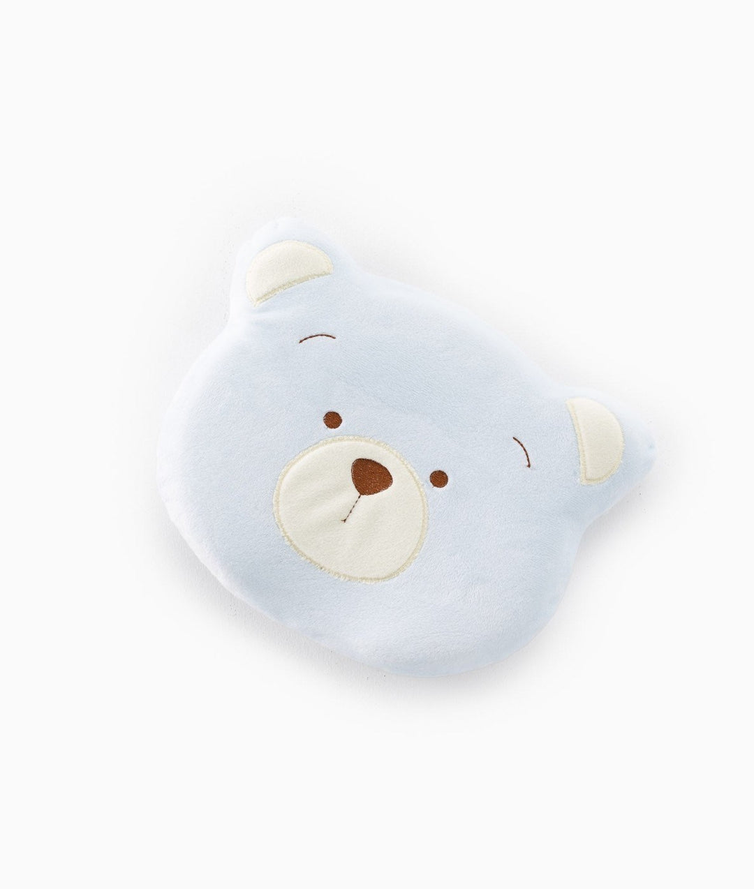 Top-down view of light blue baby bear pillow showing symmetrical cream ear accents and stitched snout