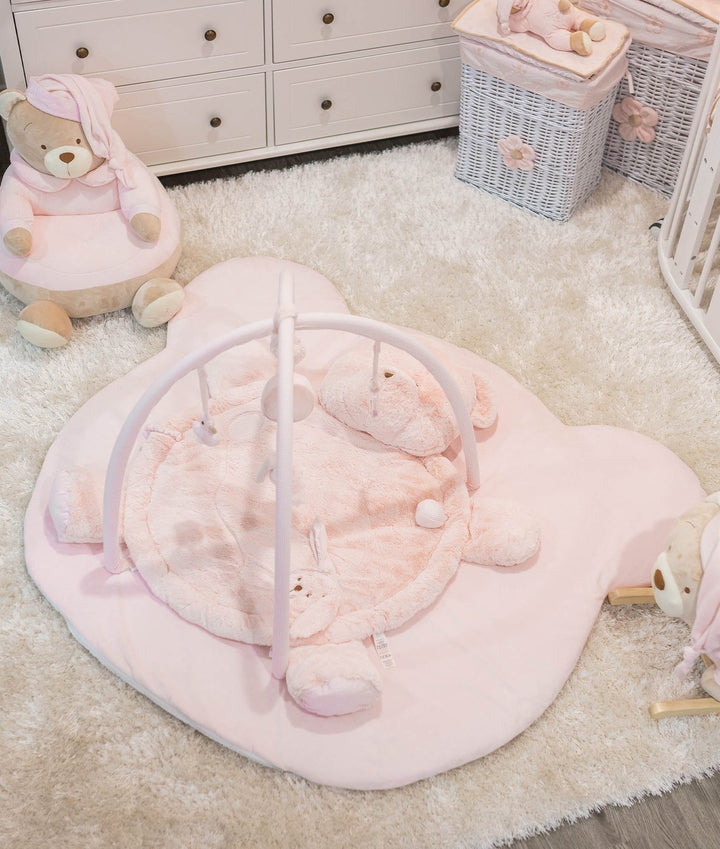 Pink bear-shaped floor play mat with attached arch stand and hanging toys