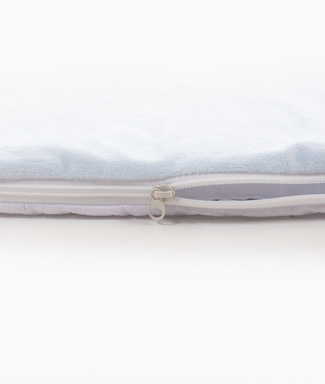 Side profile of blue plush playmat showing padding thickness and zipper pull tab detail
