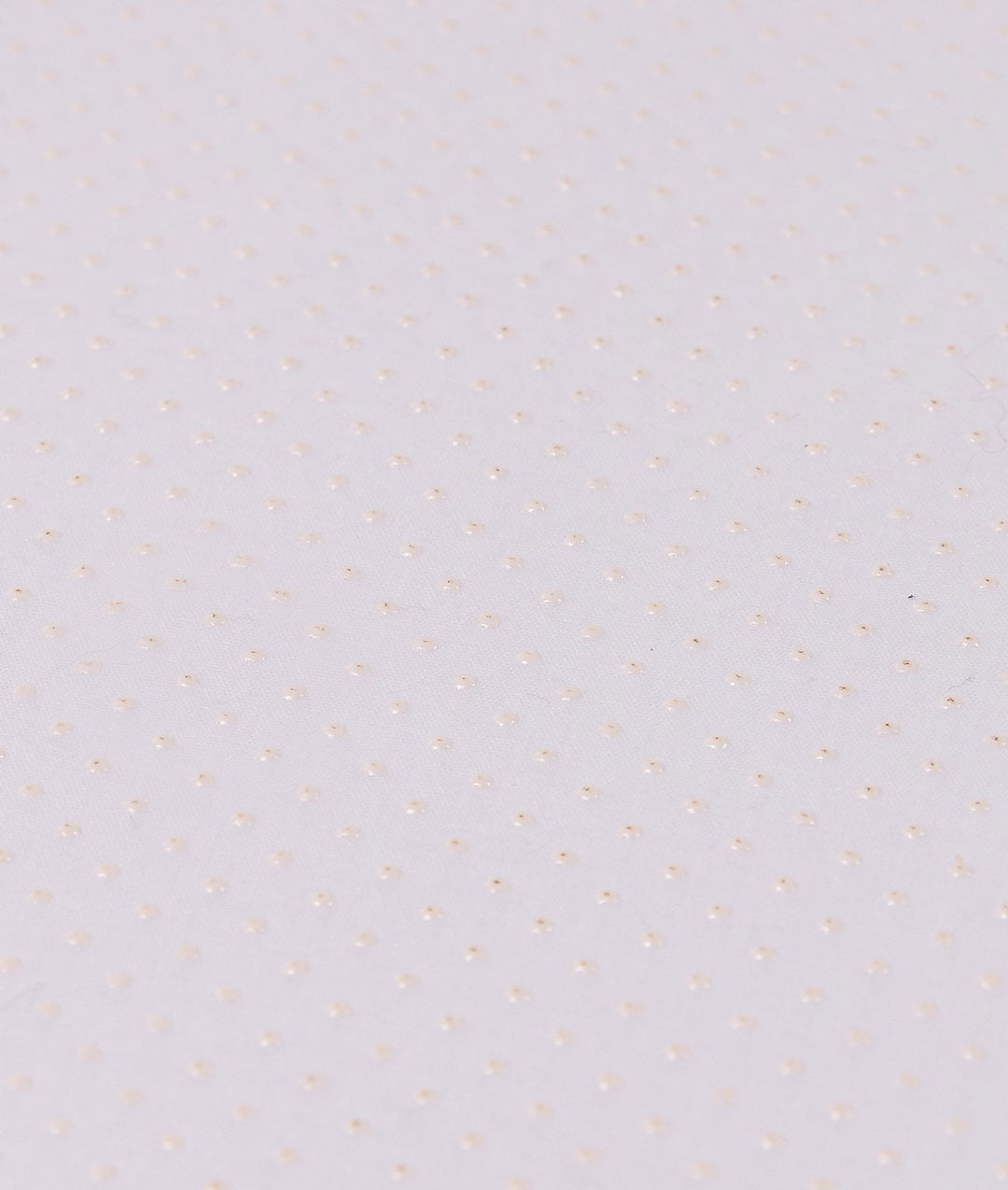 Macro shot of white anti-slip backing with raised rubber dot grid pattern for grip stability