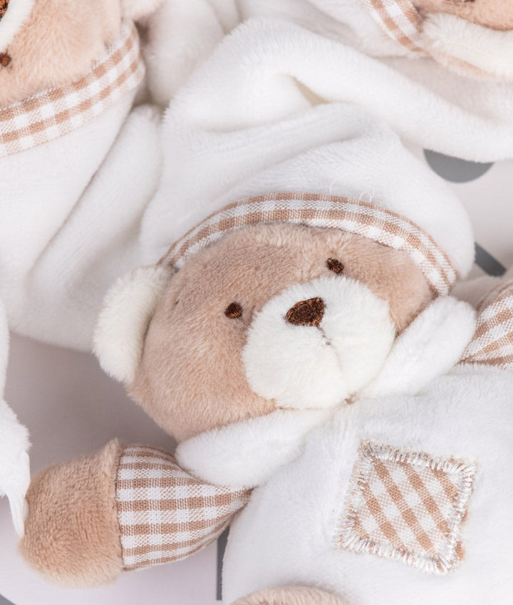 Close-up of embroidered bear face with gingham trim and textured chest patch