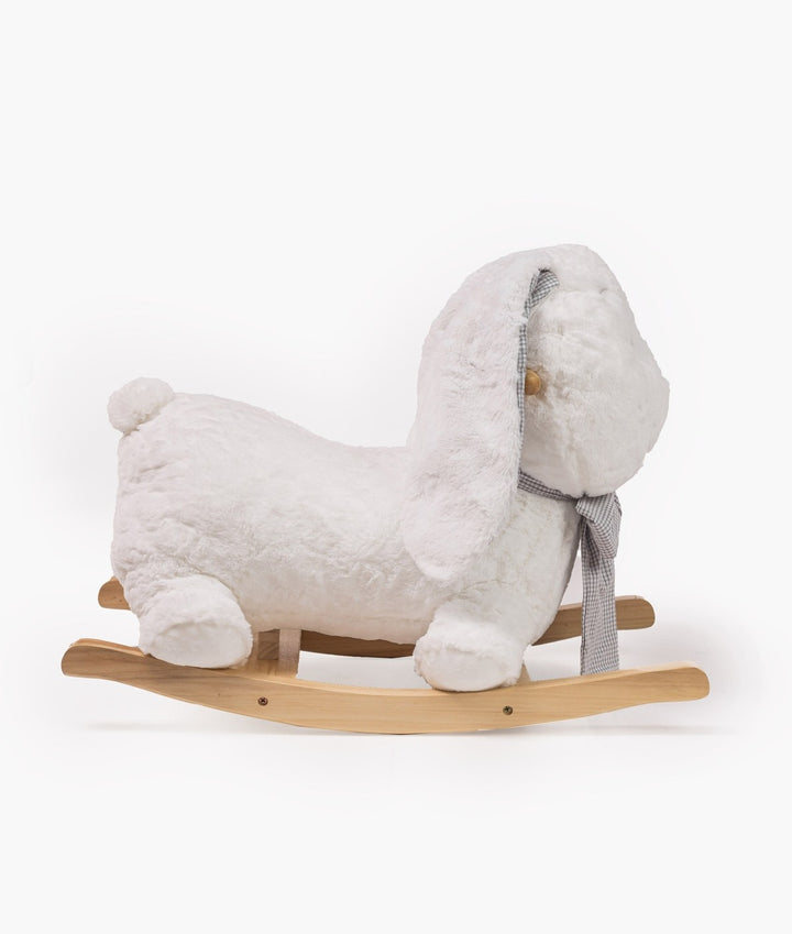 Side profile of white plush rocking bunny displaying rounded tail and curved wooden rocker base