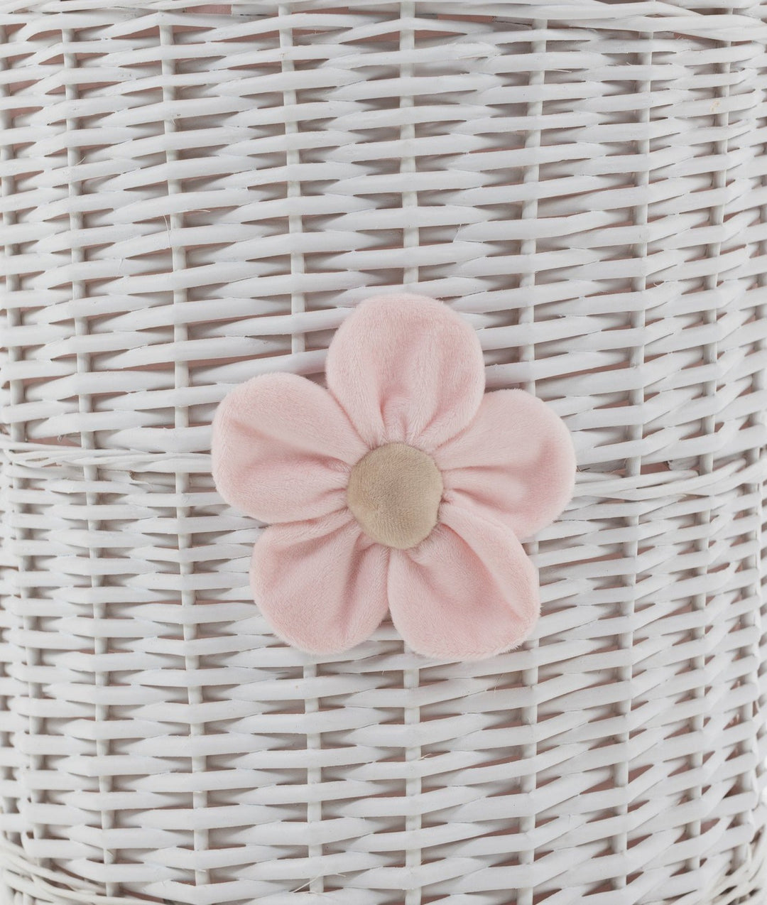 Close-up of white wicker basket texture with pink fabric flower applique