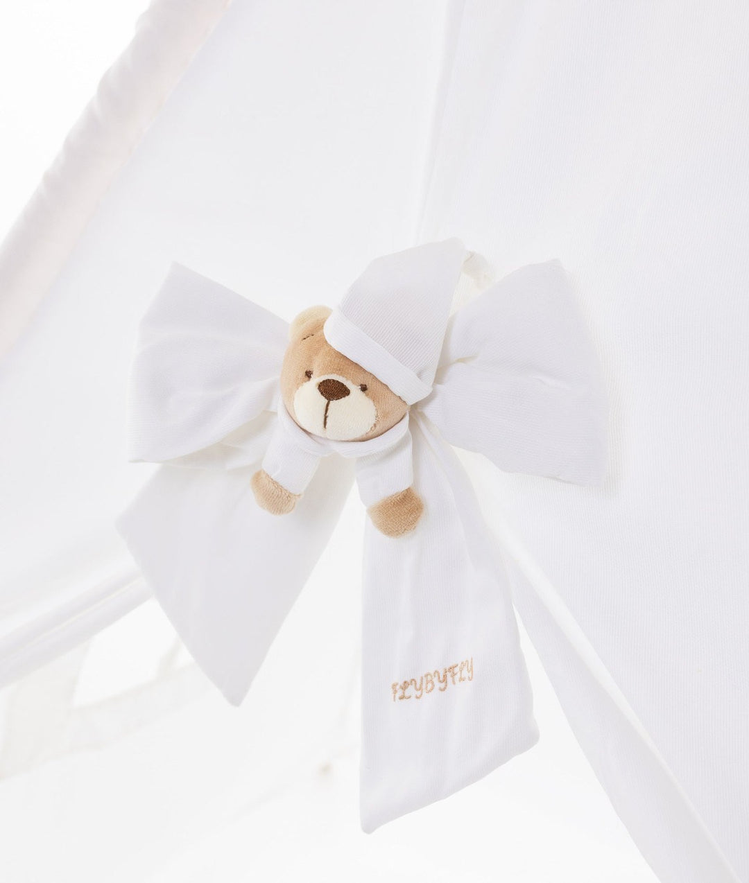 Teddy bear head tie-back detail on white teepee tent ribbon