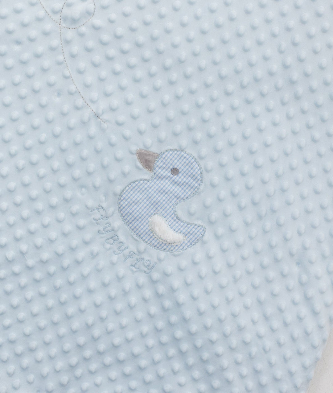 Close-up of light blue bubble fabric with gingham duck applique and embroidered logo