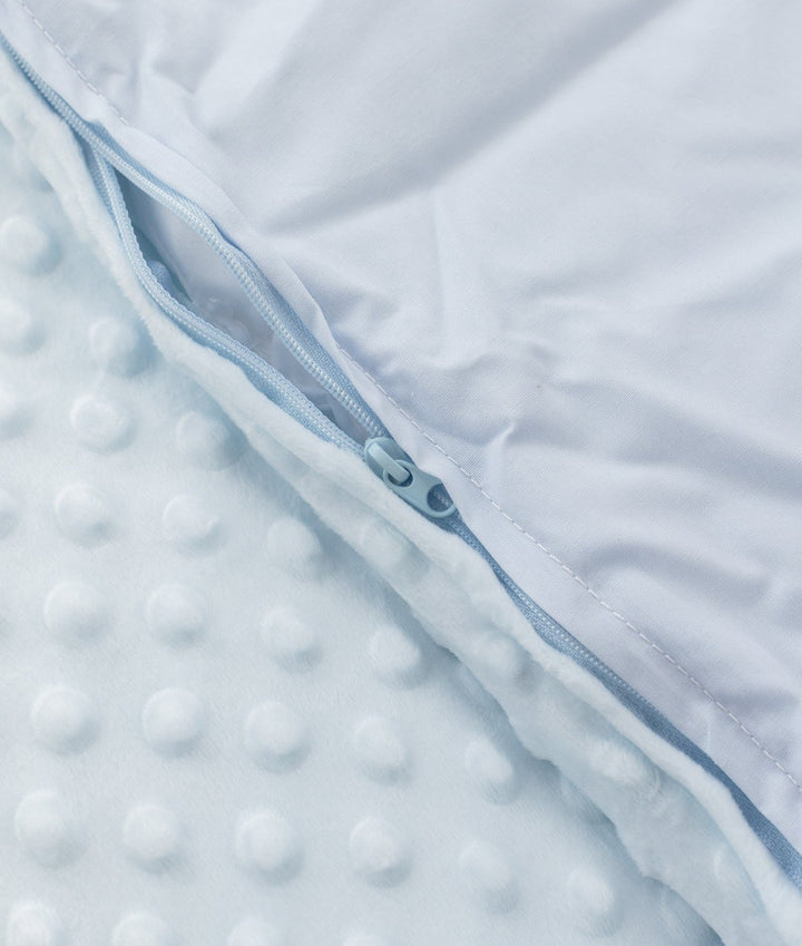 Detail of light blue zipper track separating bubble fabric from smooth white lining