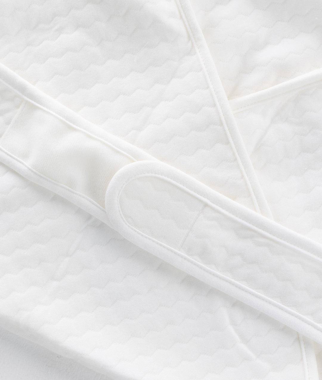 White and beige newborn swaddle blanket